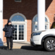 Front View Of Police Officer Looking At Cop Car