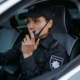 Security Guard In Patrol Vehicle On Radio