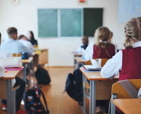Students In Uniforms Studying In Classroom