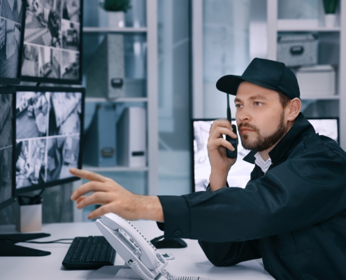 Guard Inspecting Surveillance Feed