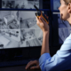 Female Security Guard With Portable Transmitter Monitoring Modern Cctv Cameras Indoors