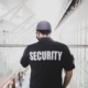 Security Guard In Uniform Patrolling In A Commercial Building
